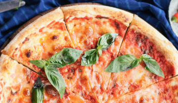Image of a Margherita pizza on a wooden board